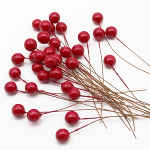 Vibrant red artificial berries with glossy coating for festive home decor DIY projects