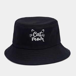 Detail of white Cat Mom embroidery and stitching on a black cotton bucket hat