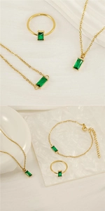 Dettaglio del set di gioielli con pietre preziose verde smeraldo e catena dorata