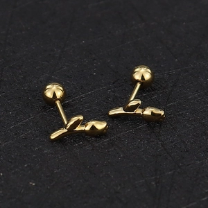 Macro detail of gold-plated tulip flower stud earrings with secure screw-back ball