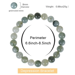 Detailed view of 8mm greenweed stone beaded bracelet with natural textures on white background