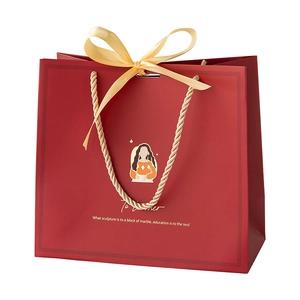 Elegant red teacher gift bag with yellow silk bow and gold handles for appreciation gifts