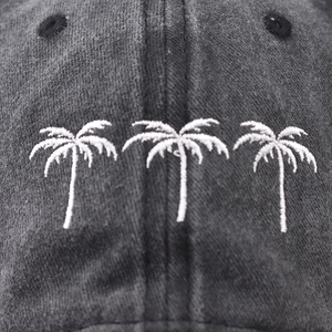 Washed cotton baseball cap featuring white palm tree embroidery and breathable eyelets