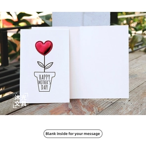 Detail of DIY leather heart Mother's Day card with Happy Mother's Day text on wooden table