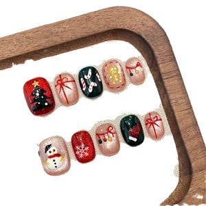 Handmade Christmas press-on nails with 3D tree, snowman, and gingerbread man motifs