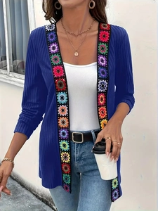 Blue ribbed knit cardigan featuring colorful crochet flower trim and long sleeves