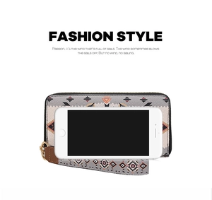 Ethnic patterned long wallet with wristlet strap shown next to a smartphone for size comparison