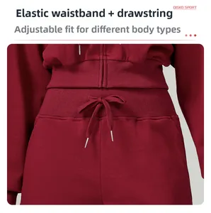 Detail of high waist elastic drawstring waistband on dark red fleece sports trousers