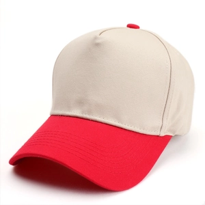 Detail view of a two-tone baseball cap in beige and red with durable stitching