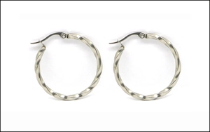 Macro detail of silver twisted hoop earrings featuring spiral texture and clasp