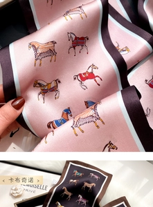 Detailed view of pink and brown silk scarf featuring hand-painted horse patterns
