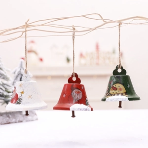 Three hand-painted iron Christmas bell ornaments with Santa and Snowman hanging on a branch