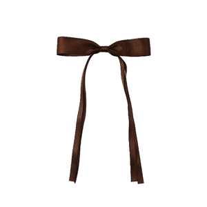 Detailed view of a dark brown satin ribbon bow hair clip on a plain white background