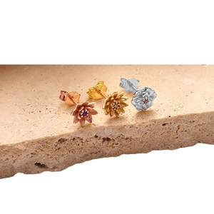 Three pairs of 925 silver December flower stud earrings in gold, silver, and rose gold