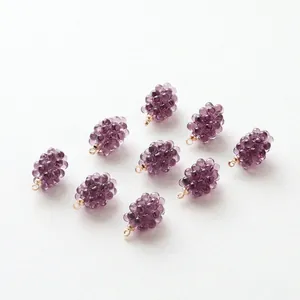 Close-up of ten purple resin grape charms with gold hanging loops for DIY jewelry making