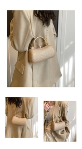 Detail of elegant gold glitter evening clutch bag with round metal handle and chain strap