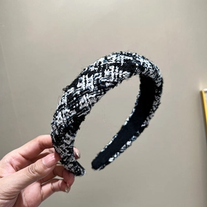 Close-up of black and white tweed wide headband showing woven fabric texture and details
