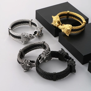Detail of wolf head bracelets in gold, silver, gunmetal, and black with braided texture