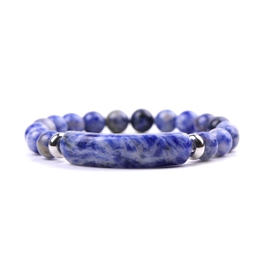 Detail of blue and white marble beaded bracelet with silver metal spacers and cylinder charm