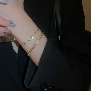 Close-up of gold-plated star flower zircon bracelet set styled on a model wrist