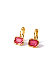 Macro shot of gold earrings featuring rectangular rose red cubic zirconia stones