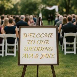 Custom wood frame wedding welcome sign with gold glitter letters on outdoor lawn