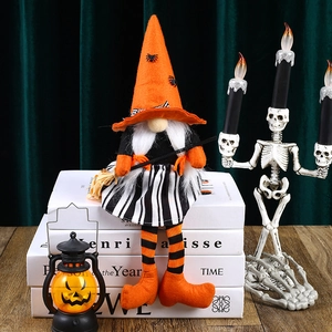 Detail of Halloween gnome with orange wizard hat, white beard, and broomstick accessory