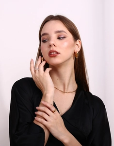 Close-up of elegant 18K gold plated snake chain necklace and jewelry set on model
