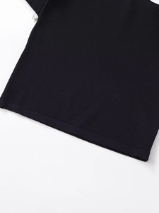 Close-up of fine black knit fabric texture and hem stitching on a short sleeve T-shirt