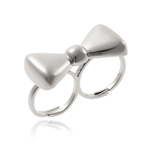 Detailed close-up of a silver double-finger ring featuring a 3D metallic bow design