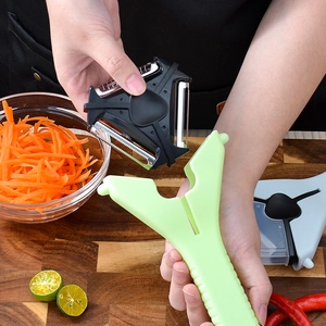 3-in-1 rotary fruit peeler and vegetable grater with stainless steel blades on wood