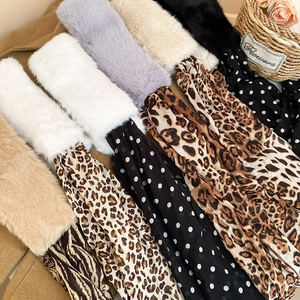 Close-up of leopard and dot print scarves with soft faux fur collars for winter warmth