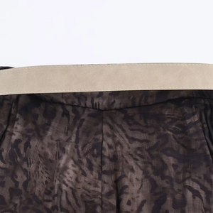 Detail of waist stitching on leopard print midi dress with smooth beige waistband