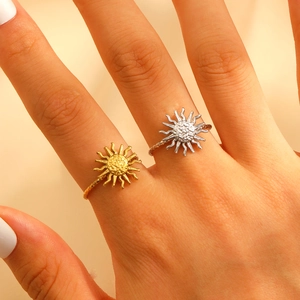 Adjustable sunburst rings in gold and silver finish with textured rays on twisted bands