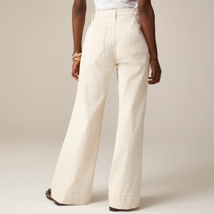 Detail view of high waisted beige wide leg pants with back pockets and contrast stitching