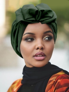 Detailed close-up of dark green French vintage turban with pleated ruffle design on model