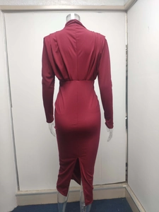 Detail view of wine red slim fit midi dress featuring a stylish back hem slit detail