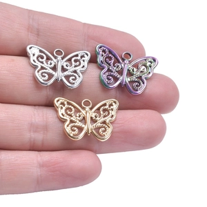 Detailed view of hollow butterfly charms in gold, silver, and iridescent finishes for DIY