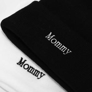 Close-up of Mommy embroidery on premium knitted beanies in black and white styles