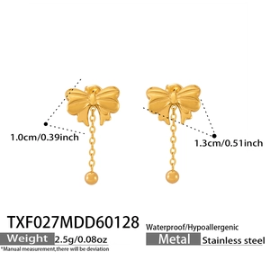 Detailed macro view of bow earrings in stainless steel with elegant gold fringe tassels