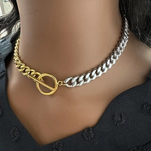 Close-up of dual-tone gold and silver Cuban chain necklace with OT toggle clasp