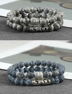 Detail of beaded bracelets with buddha head charms, blue dragon and grey marble stone beads