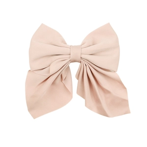 Front view of a large multi-layered pink satin bow hair clip with glossy texture