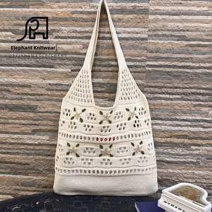 Close-up of handmade crochet tote bag with 3D green leaves and flower embroidery