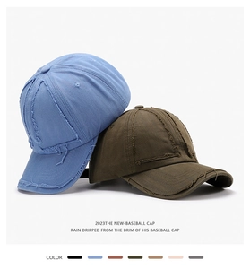 Detail of distressed vintage cotton baseball caps with frayed seams and multiple colors