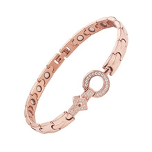 Detailed view of rose gold magnetic therapy bracelet with white rhinestones