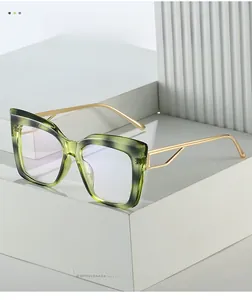Detailed macro of green marble cat-eye frame and hollow gold metal temple hinges