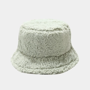 Detail of light green faux fur bucket hat showing soft, thick plush texture for winter