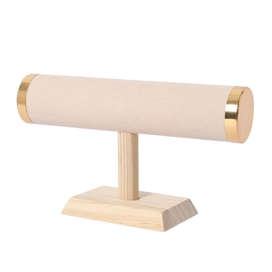 Close-up of T-bar jewelry stand with wood base, beige velvet and gold metal caps