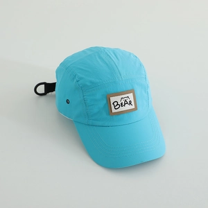 Detailed view of blue quick-dry camper hat with BEAR patch and breathable side vents